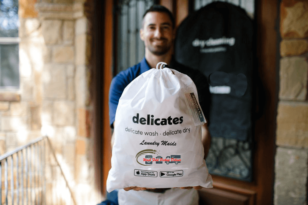 A man holding a bag of laundry outside.