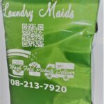 A bag of laundry detergent that is green.