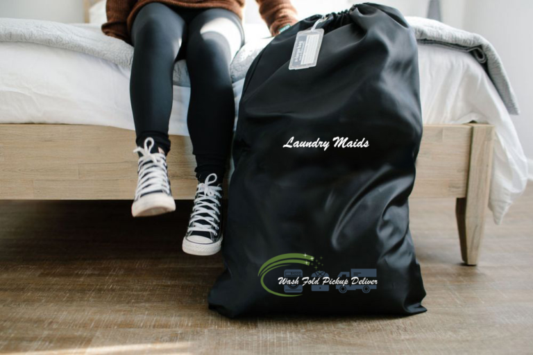 A person sitting on the ground with a laundry bag.