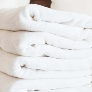 A stack of white towels on top of each other.